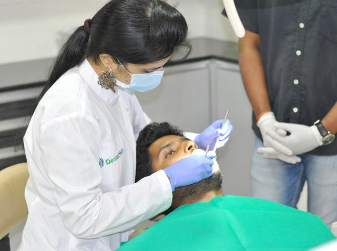 Dentist operating Patients - Dental Hub