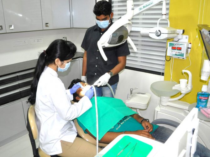 Dentist operating Patients- Dental Hub